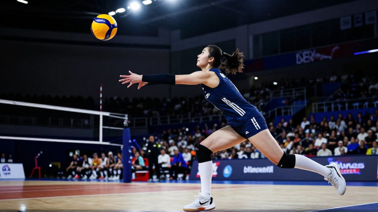 A female volleyball player performs a powerful jump serve in a brightly lit indoor arena.