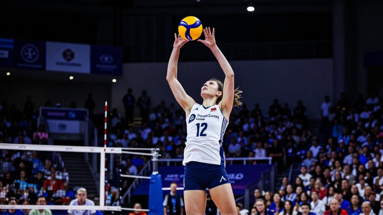 A female volleyball player leaps mid-air to spike a ball during a professional tournament.