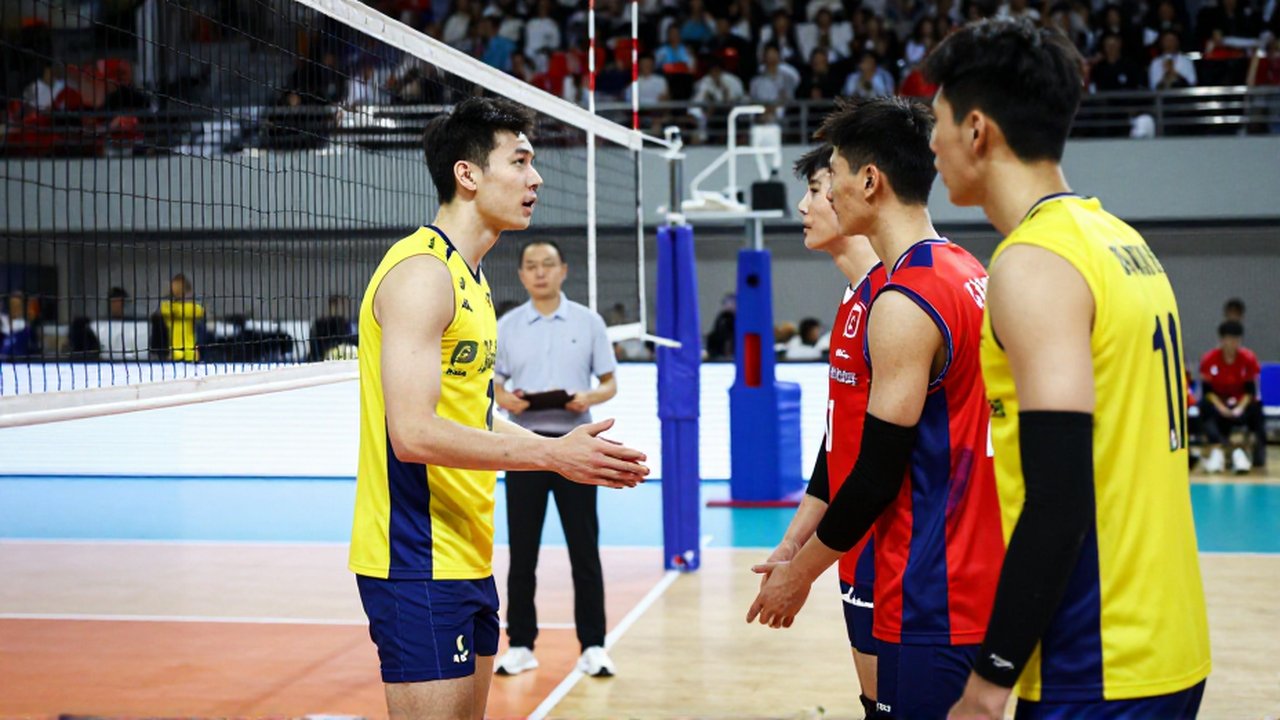 A volleyball player intensely communicates with a teammate near the sideline during a tactical break.